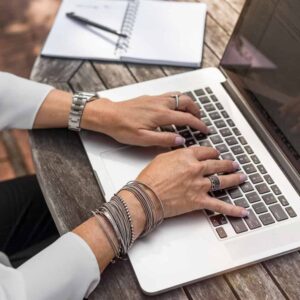 woman typing email newsletter ideas on a laptop